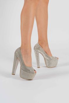 a woman's legs wearing high heels with silver glitter finish and peep toes