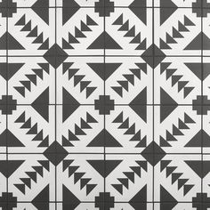 a black and white pattern with triangles on it