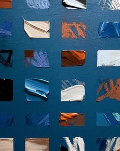 many different types of paint on a blue surface