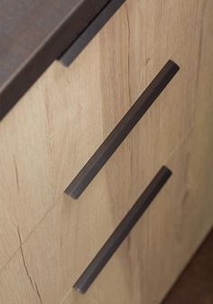 a close up of a wooden drawer with metal pulls on the doors and drawers,