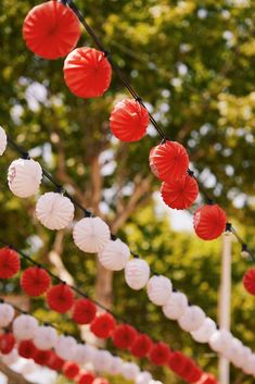 red and white paper lanterns strung from trees