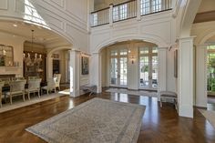 a large living room with high ceilings and wooden floors