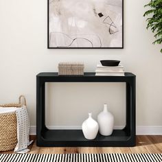 two white vases sitting on top of a black table in front of a painting