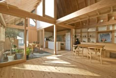 the interior of a house with wood flooring and wooden walls, windows, and ceiling