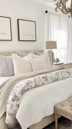 a bedroom with a bed, chair and chandelier