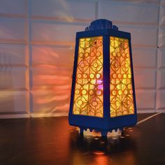 a colorful lamp sitting on top of a wooden table