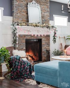 a living room filled with furniture and a fire place in front of a brick fireplace