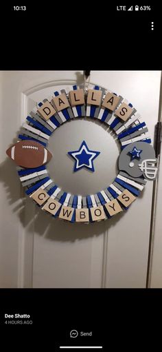 a football themed wreath is hanging on the front door, and it says dallas cowboys