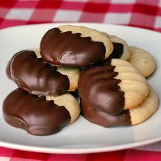 chocolate covered heart shaped cookies on a plate with the words melting moments written below it