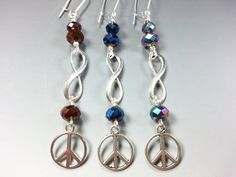 "These Pretty, Extra Sparkly Earrings are part of my \"For a More Peaceful World\" Collection. They are made from Tibetan Silver Peace Symbols and Infinity Signs with Titanium Plated Crystal Beads in your choice of 3 Colors: Dark Purple, Brilliant Blue, and Multi-Color Rainbow. They are 2-3/4 inches long ( not including the silver plated Kidney Style ear wires) and are very light weight. It's possible for me to make this same style of earrings with Other Colors of Crystal Beads. Please message m Infinity Signs, Peace Symbols, Semiprecious Stone Jewelry, Color Rainbow, Sparkly Earrings, Same Style, Dark Purple, Stone Jewelry, Ear Wires