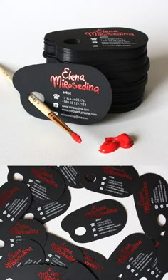 some black and white business cards with red writing on them