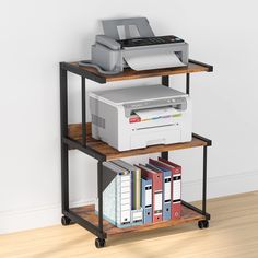 a computer desk with printer, scanner and other office equipment on it's shelf