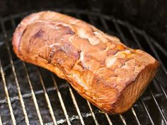 a piece of meat is cooking on the grill