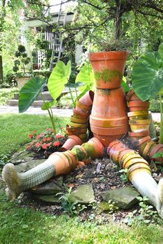 an assortment of pots and plants in a garden