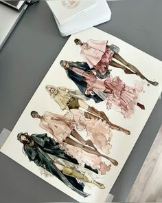 an image of three women in different outfits on a piece of paper next to a laptop