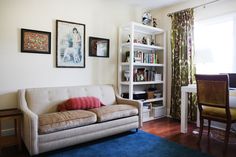 a living room filled with furniture and bookshelves