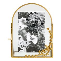 an ornate gold frame with flowers in it