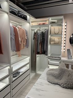 a walk in closet filled with lots of clothes