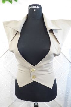 Stylish women's vest in beige color with additional parts.  The model can be made in other colors. Available sizes - IZE-EU-XXS-34 Bust-78cm.-80cm. Waist-58cm.-62cm. Hips - 84cm.-88cm. SIZE-USA-0 Bust -30.50in.-31in. Waist- 22.50in.-24in. Hips-33in.-34.50in. --------------------------------------------------- ------------------------------------ SIZE-EU-XS-36 Bust-81cm.-85cm. Waist-64cm.-67cm. Hips -88cm.-91cm. SIZE-USA-2 Bust-32in.-33.50in. Waist -25in.-26in. Hips-34.50in.-35.50in --------------------------------------------------- -------------------------------- SIZE-EU-S-37-38 Bust - 85cm.-89cm. Waist - 67cm.-71cm. Hips-91cm.-95cm. SIZE-USA-4 Bust -33in.-35in. Waist-26in.-28in. Hips-35.50in.-37.50in. --------------------------------------------------- ---------------------------------- Chic Stretch Beige Vest, Chic Beige Stretch Vest, Fitted Khaki Vest For Work, Fitted Sleeveless Top In Neutral Color, Taupe Fitted Sleeveless Top, Fitted Taupe Sleeveless Top, Fitted Sleeveless Taupe Top, Fitted Beige Summer Outerwear, Fitted Beige Outerwear For Summer