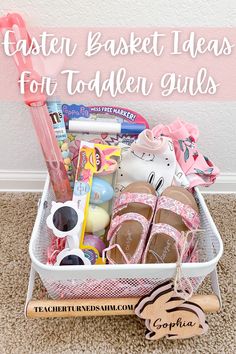 a basket filled with toys and other items on top of a carpeted floor next to a pink wall