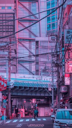 a city street filled with lots of traffic and tall buildings under a pink hued sky