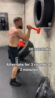 a man is doing exercises with two tires in the background, and an image of a tire on the wall