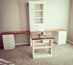 an empty room with a desk and shelves