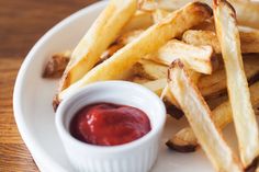 french fries with ketchup on a white plate