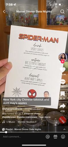 someone holding up a spiderman menu in front of the camera with other photos on it