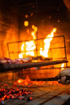 a pizza being cooked in an oven with flames