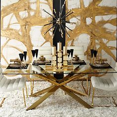 a modern dining room with gold and white decor