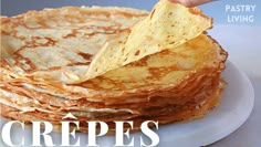 a stack of pancakes on a plate with a hand holding a tortilla chip