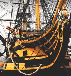 an old sailing ship with ropes on the deck