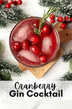 cranberry gin cocktail in a glass garnished with rosemary and cherries