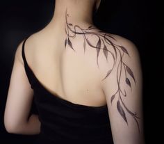 the back of a woman's neck with leaves on it