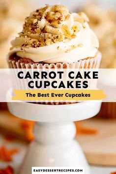 carrot cake cupcakes with white frosting and walnut sprinkles on top