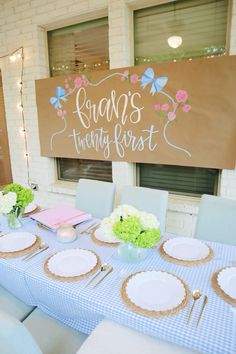 a table set up with plates and place settings in front of a sign that says king's twenty first