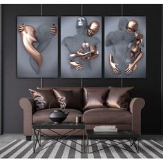 three metal art pieces hanging on the wall above a couch in a room with striped carpet