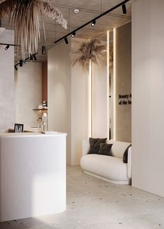 a white couch sitting next to a counter in a room with palm trees on the wall