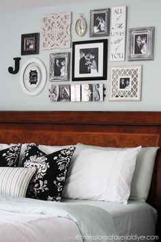 a bed room with a neatly made bed and many pictures on the wall above it