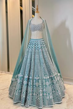 The Camellia Lehenga set is Turkish blue taffeta , heavily embroidered Lehenga set. The Dupatta is a beautiful net embroidered dupatta. DELIVERY TIMEPlease allow 8-12 weeks for your outfit to arrive. FABRIC DETAILSSilk Taffta top and lehenga Soft Net Dupatta Professional cleaning only. Types Of Lengha, Desi Bridal Lehenga, Blue Lahnga Design, Blue Lehngas, Lehenga In Blue Colour, Lengha Choli Designs, Blue Embroidered Fabric With Sheer Dupatta For Designer Wear, Blue Lehenga Outfit, Blue Sets With Intricate Embroidery For Reception