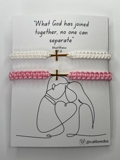 two pink and white bracelets with an image of a woman holding a cross on it