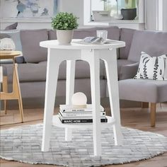 a living room with a gray couch and white table