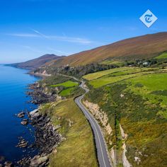 an aerial view of a road near the ocean