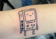 a small tattoo on the arm of a person's arm with a drawing of an old computer