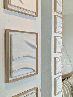 a white wall with three different paintings on it