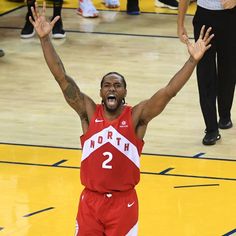 a basketball player with his arms in the air