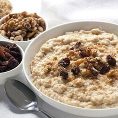 three bowls of oatmeal with walnuts and raisins