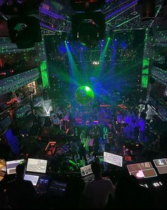 an overhead view of a concert venue with lots of green and purple lights on the stage