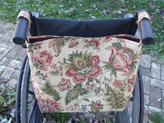 a chair with a flowered seat cover on it's back and side rests in the grass